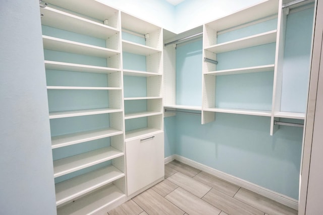 spacious closet with wood tiled floors