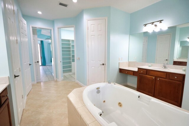 bathroom with a jetted tub and vanity