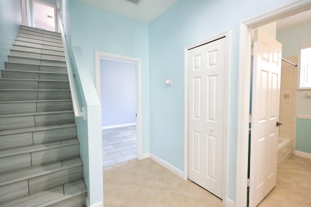 staircase with tile patterned floors and baseboards