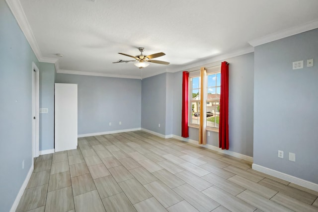 spare room with ceiling fan, crown molding, and baseboards