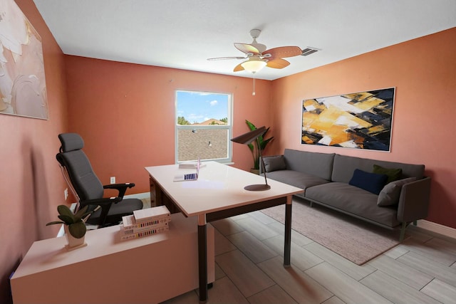 home office featuring a ceiling fan, baseboards, and wood finish floors