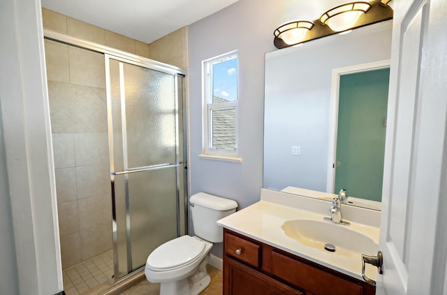 full bath featuring a stall shower, toilet, and vanity