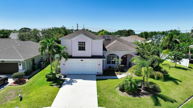 view of front of house featuring stucco siding, driveway, a front yard, cooling unit, and an attached garage