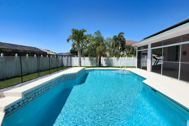 view of swimming pool featuring a fenced backyard and a patio
