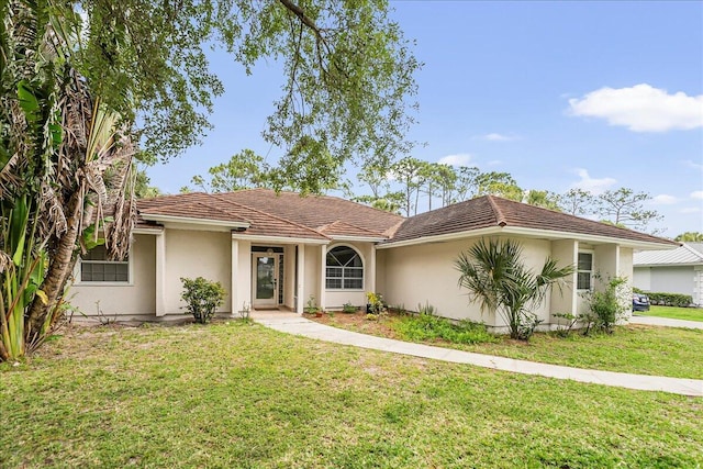 ranch-style home with a front lawn and stucco siding