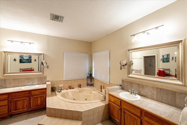 full bathroom with two vanities, visible vents, and a sink