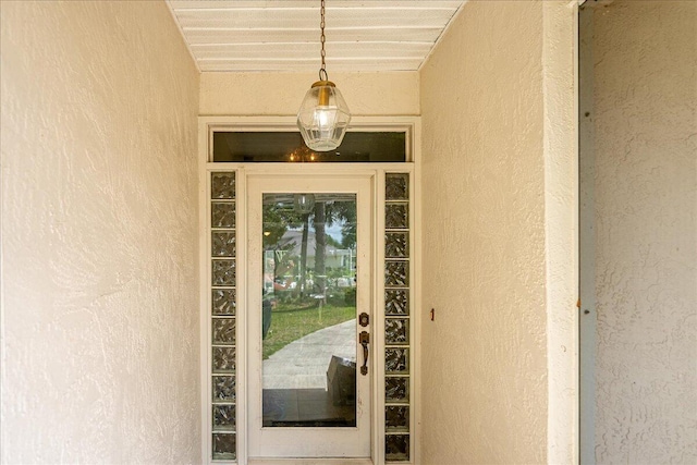 doorway to property with stucco siding