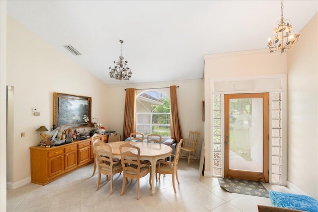 dining room with lofted ceiling, visible vents, a chandelier, and light tile patterned floors