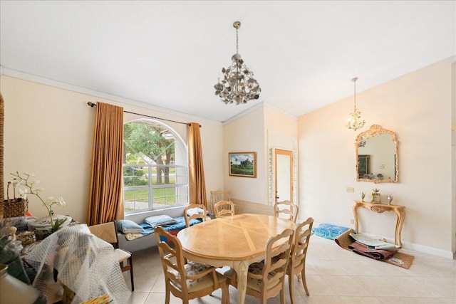 dining area featuring ornamental molding, a notable chandelier, and light tile patterned floors