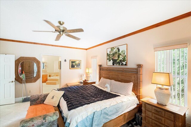 bedroom with ensuite bath, crown molding, baseboards, and ceiling fan