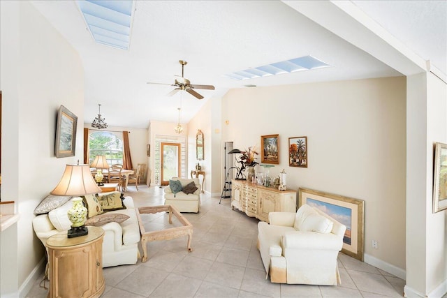 living room with high vaulted ceiling, baseboards, ceiling fan, and light tile patterned floors