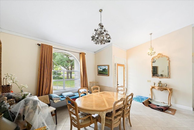 dining space with a notable chandelier, crown molding, and light tile patterned floors