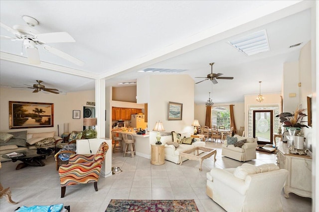 living room featuring vaulted ceiling, a ceiling fan, visible vents, and light tile patterned floors