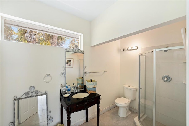 bathroom featuring a wealth of natural light, toilet, vanity, and a stall shower