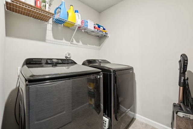 5684 Mentmore Dr, Mangonia Park, FL 33407 - washroom featuring washer and dryer, laundry area, and baseboards