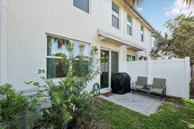 5684 Mentmore Dr, Mangonia Park, FL 33407 - rear view of house featuring fence, a patio, and stucco siding