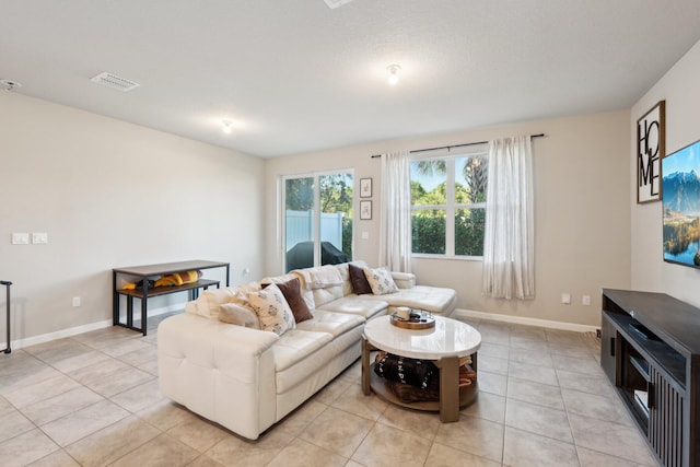 5684 Mentmore Dr, Mangonia Park, FL 33407 - living room with visible vents, baseboards, and light tile patterned floors