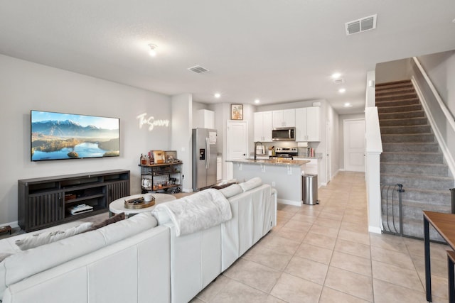 5684 Mentmore Dr, Mangonia Park, FL 33407 - living area with visible vents, recessed lighting, light tile patterned floors, and stairs