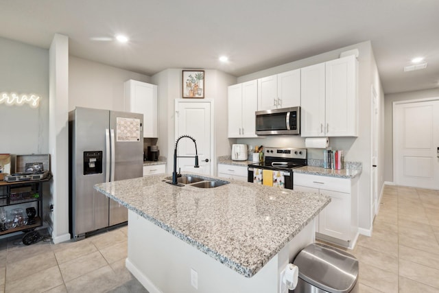 5684 Mentmore Dr, Mangonia Park, FL 33407 - kitchen featuring a sink, light tile patterned floors, white cabinets, and appliances with stainless steel finishes