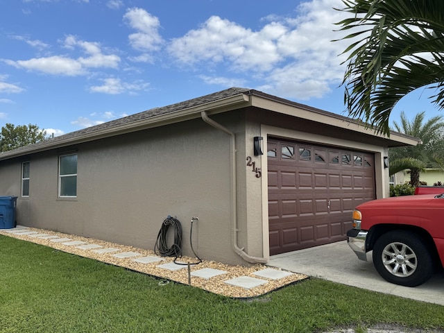 215 Monterey Way, Royal Palm Beach, FL 33411 - view of property exterior featuring stucco siding, an attached garage, and concrete driveway