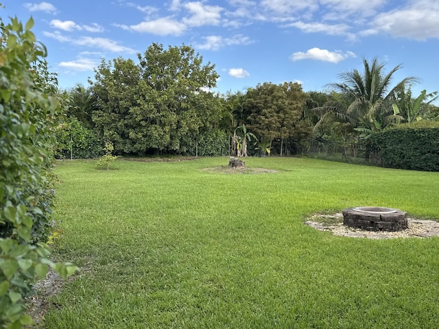 215 Monterey Way, Royal Palm Beach, FL 33411 - view of green lawn with a fire pit