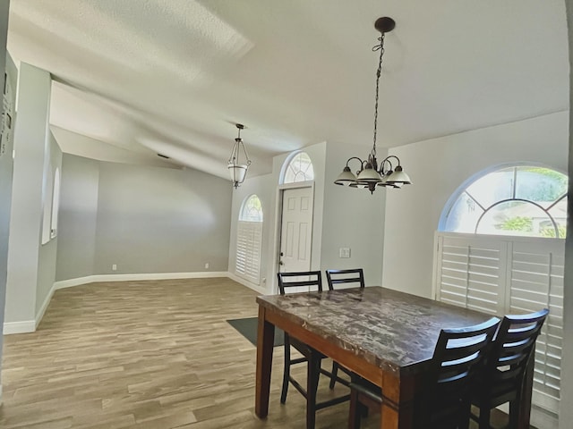 215 Monterey Way, Royal Palm Beach, FL 33411 - dining area with wood finished floors, baseboards, a chandelier, and vaulted ceiling