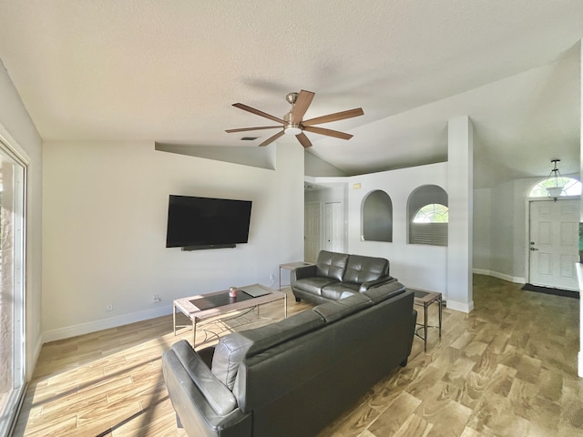 215 Monterey Way, Royal Palm Beach, FL 33411 - living room featuring lofted ceiling, ceiling fan, light wood-style floors, baseboards, and a textured ceiling