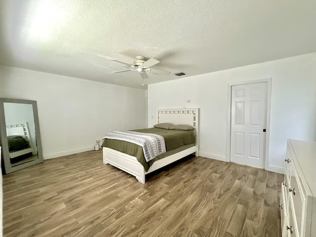 215 Monterey Way, Royal Palm Beach, FL 33411 - bedroom with light wood-style floors, a textured ceiling, baseboards, and ceiling fan
