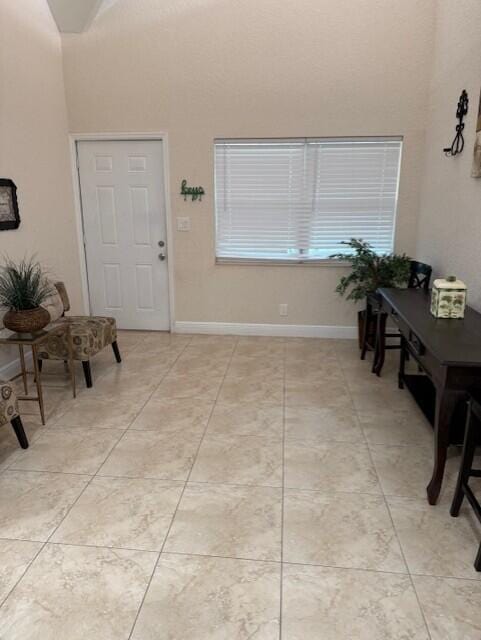 795 SW All American Blvd, Palm City, FL 34990 - entrance foyer featuring light tile patterned floors, baseboards, and a high ceiling