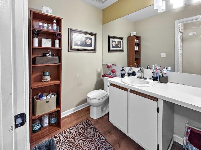 3696 Timberline Dr, West Palm Beach, FL 33406 - half bathroom featuring vanity, visible vents, toilet, and wood finished floors