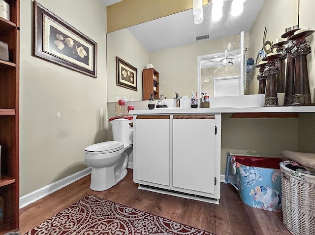 3696 Timberline Dr, West Palm Beach, FL 33406 - bathroom featuring vanity, baseboards, toilet, visible vents, and wood finished floors