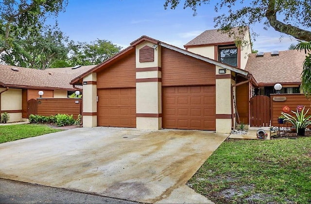3696 Timberline Dr, West Palm Beach, FL 33406 - view of front of home with concrete driveway, a garage, stucco siding, and fence