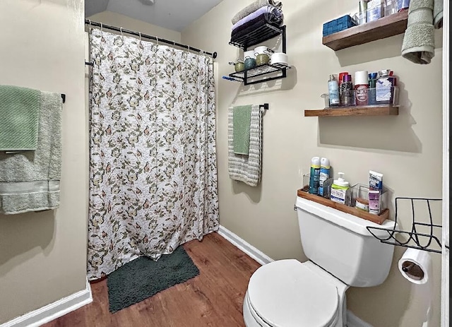 3696 Timberline Dr, West Palm Beach, FL 33406 - bathroom with toilet, wood finished floors, baseboards, and a shower with shower curtain
