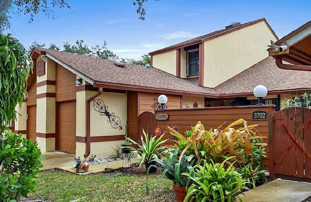 3696 Timberline Dr, West Palm Beach, FL 33406 - exterior space featuring fence, roof with shingles, stucco siding, and a gate