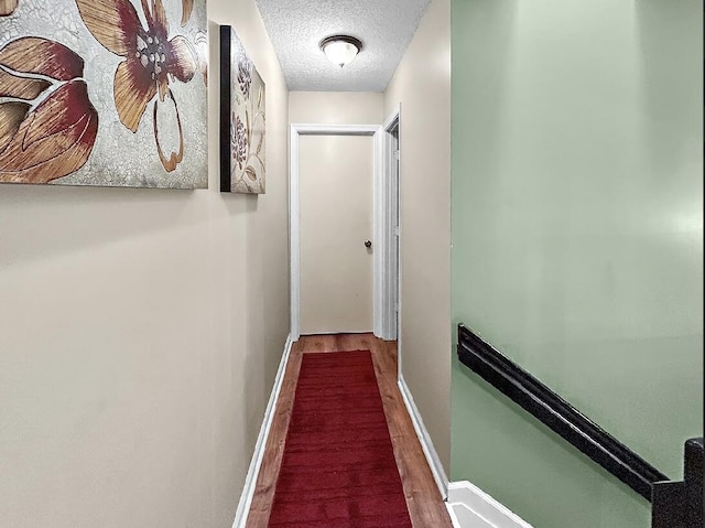 3696 Timberline Dr, West Palm Beach, FL 33406 - hall with baseboards, wood finished floors, and a textured ceiling