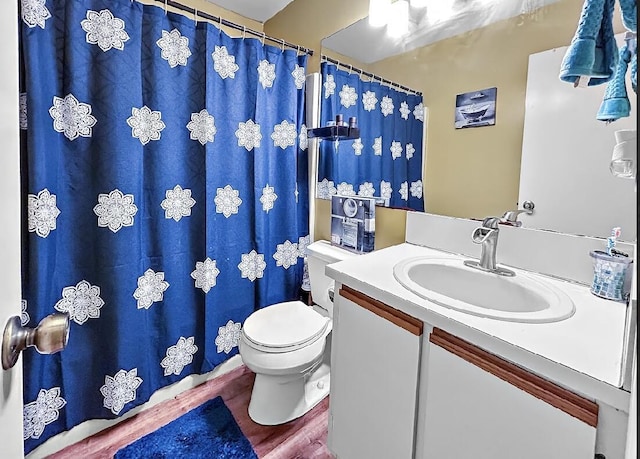3696 Timberline Dr, West Palm Beach, FL 33406 - full bath with toilet, wood finished floors, vanity, and a shower with shower curtain
