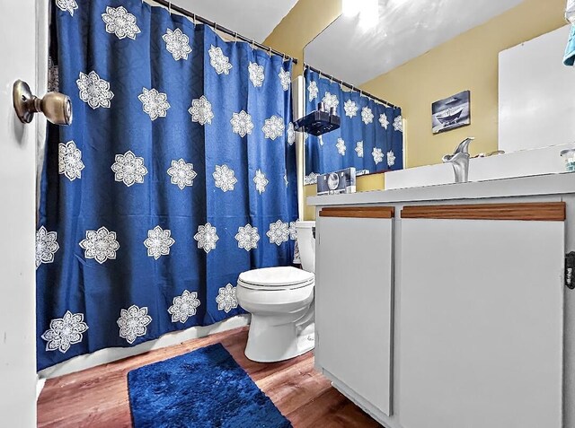 3696 Timberline Dr, West Palm Beach, FL 33406 - full bathroom with curtained shower, vanity, toilet, and wood finished floors