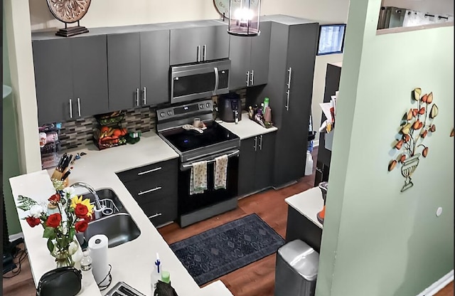 3696 Timberline Dr, West Palm Beach, FL 33406 - kitchen with light countertops, black / electric stove, stainless steel microwave, backsplash, and pendant lighting
