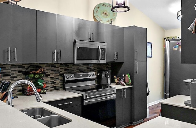 3696 Timberline Dr, West Palm Beach, FL 33406 - kitchen featuring tasteful backsplash, appliances with stainless steel finishes, a sink, and dark cabinets