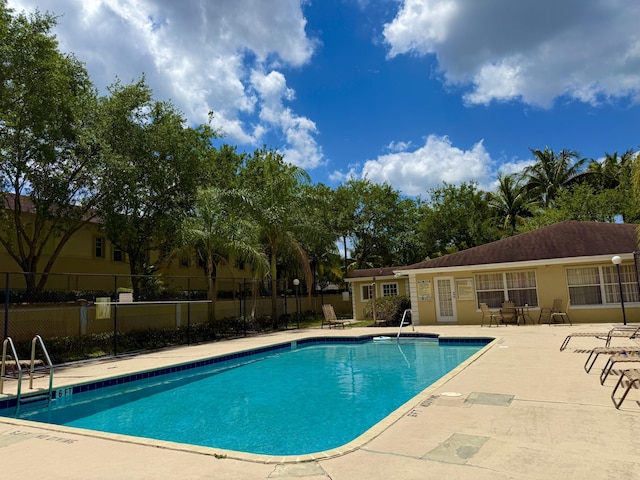 208 Palm Beach Trace Dr, Royal Palm Beach, FL 33411 - community pool with a patio