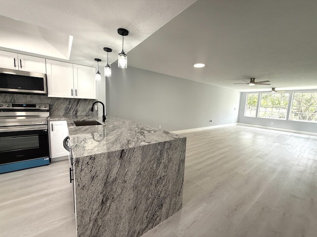 208 Palm Beach Trace Dr, Royal Palm Beach, FL 33411 - kitchen featuring appliances with stainless steel finishes, a sink, a peninsula, ceiling fan, and light wood finished floors