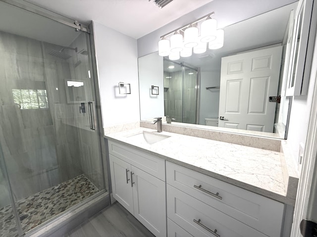 208 Palm Beach Trace Dr, Royal Palm Beach, FL 33411 - bathroom featuring vanity, a shower stall, toilet, and wood finished floors
