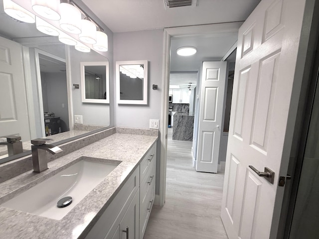 208 Palm Beach Trace Dr, Royal Palm Beach, FL 33411 - bathroom with wood finished floors and vanity