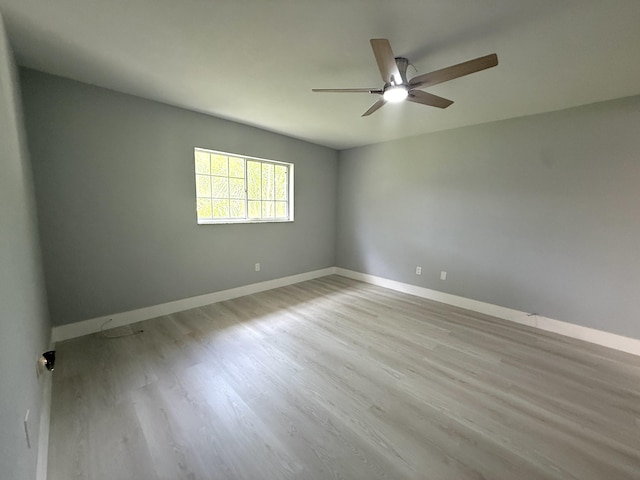 208 Palm Beach Trace Dr, Royal Palm Beach, FL 33411 - spare room featuring ceiling fan, wood finished floors, and baseboards