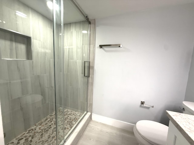 208 Palm Beach Trace Dr, Royal Palm Beach, FL 33411 - bathroom with toilet, vanity, a shower stall, wood finished floors, and baseboards
