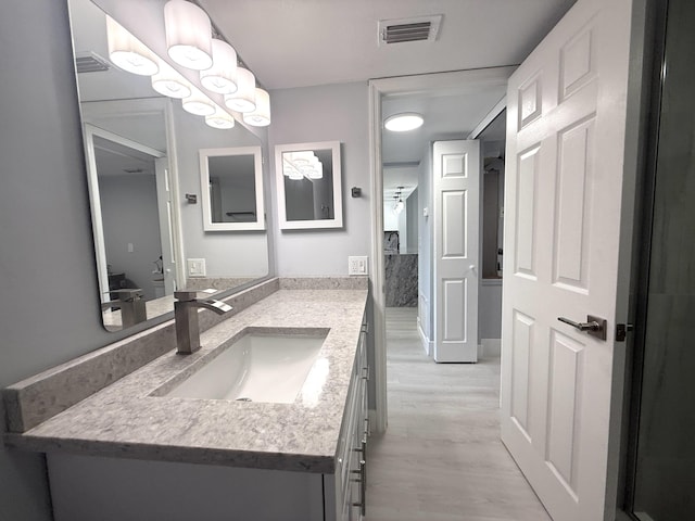 208 Palm Beach Trace Dr, Royal Palm Beach, FL 33411 - bathroom with wood finished floors and vanity