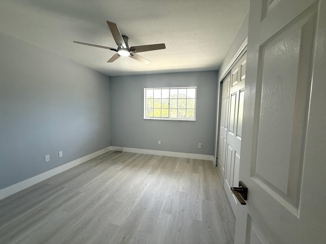 208 Palm Beach Trace Dr, Royal Palm Beach, FL 33411 - unfurnished bedroom with light wood-style floors, baseboards, a closet, and a ceiling fan