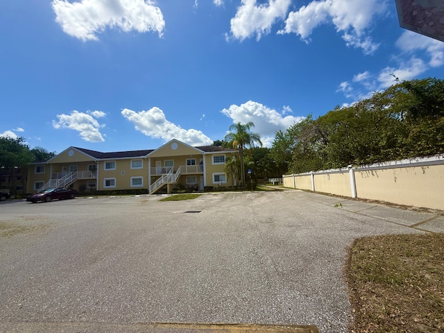 208 Palm Beach Trace Dr, Royal Palm Beach, FL 33411 - view of front of property with stairway and uncovered parking