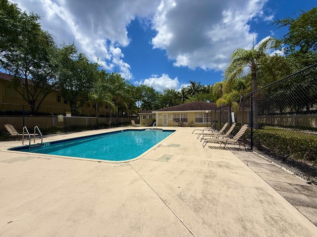 208 Palm Beach Trace Dr, Royal Palm Beach, FL 33411 - community pool with a patio area
