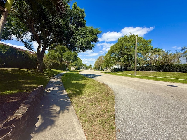 208 Palm Beach Trace Dr, Royal Palm Beach, FL 33411 - view of asphalt street featuring sidewalks and street lights